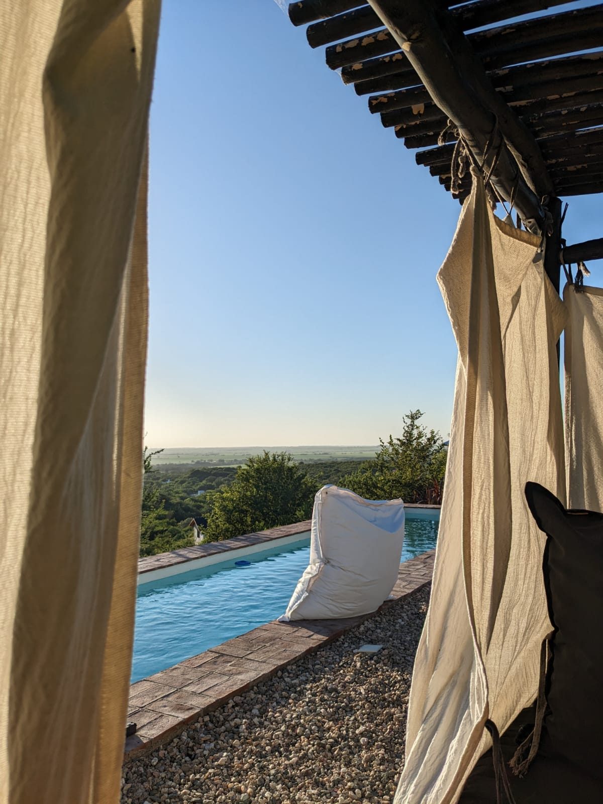 Pool view through the pergola at golden hour